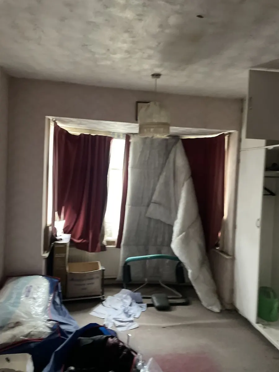 Bedroom of a purchased property left full of belongings and requiring clearance